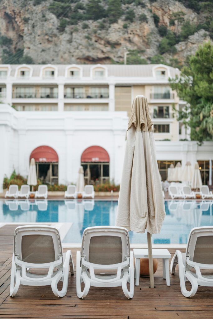 Elegant poolside scene at a luxury resort featuring loungers and umbrellas.